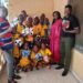 Sonia Harrison, CEO of the Fatimah Project, poses with ANSSA players after donating footballs in Monrovia.