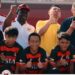 Liberian football coach Albert Kamara sits beside academy staff and regional sports officials during a youth football development session in Brunei.