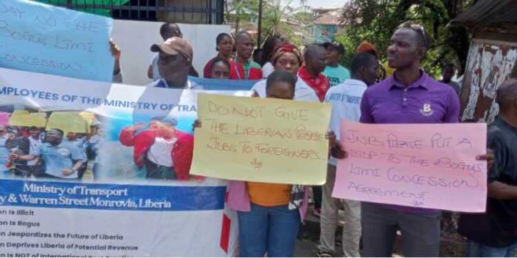 Transport Ministry staff protest in Monrovia holding placards against the Liberia Traffic Management Incorporated concession deal