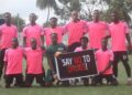 Liberia football team holding a “Say No to Drugs” sign before a match, promoting LFA’s upcoming mandatory drug testing policy