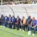Liberian football officials and FIFA delegates seated at Gompa Stadium during the inauguration of the new FIFA-funded artificial turf and mini-pitches to expand grassroots football in Liberia.