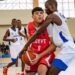 Liberian youth basketball player in white jersey defending an Egyptian opponent during a FIBA-sanctioned game.