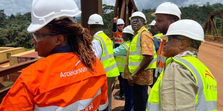 Liberian lawmakers and ArcelorMittal officials wearing safety gear during an oversight visit to inspect concession compliance under the Mineral Development Agreement