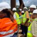 Liberian lawmakers and ArcelorMittal officials wearing safety gear during an oversight visit to inspect concession compliance under the Mineral Development Agreement