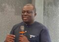 BudgIT Liberia’s outgoing Country Lead Abraham Varney speaking into a microphone during a public event in Monrovia before the organization’s leadership transition