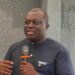 BudgIT Liberia’s outgoing Country Lead Abraham Varney speaking into a microphone during a public event in Monrovia before the organization’s leadership transition