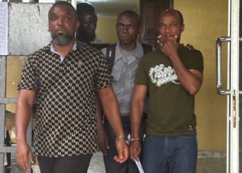 Two Afriland First Bank employees in police custody in Monrovia after being charged in connection with a $165,000 fraud scheme defrauding clients and companies.