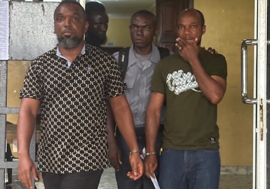 Two Afriland First Bank employees in police custody in Monrovia after being charged in connection with a $165,000 fraud scheme defrauding clients and companies.