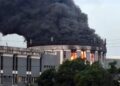 Thick black smoke and flames rise from the Liberian Capitol Building during the arson attack at the center of a high-profile trial over evidence suppression.