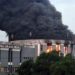 Thick black smoke and flames rise from the Liberian Capitol Building during the arson attack at the center of a high-profile trial over evidence suppression.
