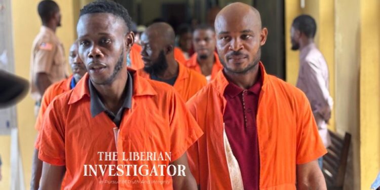 Defendants in orange prison uniforms escorted to court during the Capitol Building arson case in Monrovia