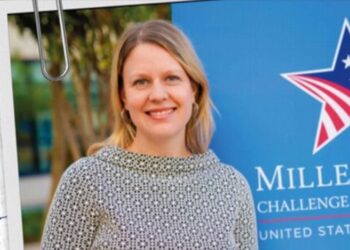 Carrie Monahan, MCC’s Managing Director for Africa, pictured near MCC banner as U.S. delegation arrives in Liberia to assess readiness for a second Compact