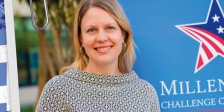 Carrie Monahan, MCC’s Managing Director for Africa, pictured near MCC banner as U.S. delegation arrives in Liberia to assess readiness for a second Compact