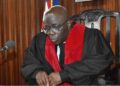 Liberia’s Chief Justice Yarmie Quiqui Gbeisay seated in court defends the appointment of his son as an associate magistrate, saying the law permits presidential discretion.