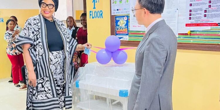 Chinese Ambassador Yin Chengwu and Health Minister Dr. Louise Mapleh Kpoto at donation ceremony for maternal health equipment in Liberia