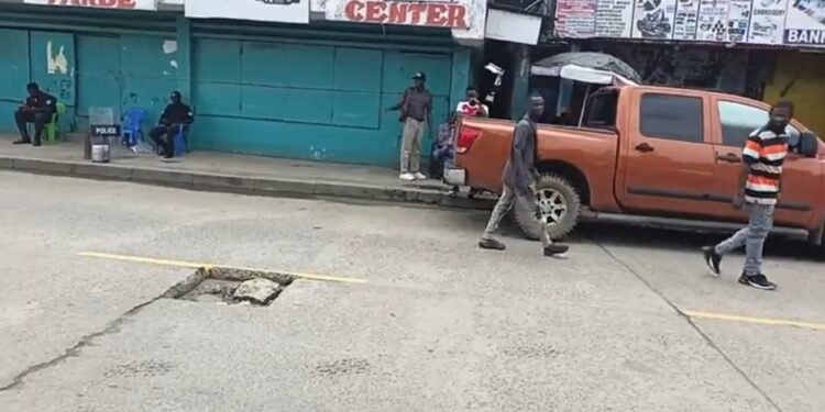 Police raid shuts down the World Trade Center on Gurley Street, Monrovia, sparking outcry from business owners and legislative intervention.
