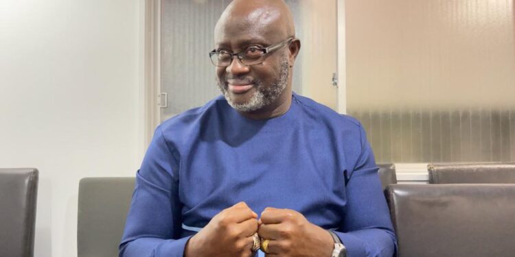 Former Sports Minister D. Zeogar Wilson in blue attire during an interview, reflecting on the Weah administration’s failure to build a sports foundation in Liberia.”