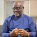 Former Sports Minister D. Zeogar Wilson in blue attire during an interview, reflecting on the Weah administration’s failure to build a sports foundation in Liberia.”