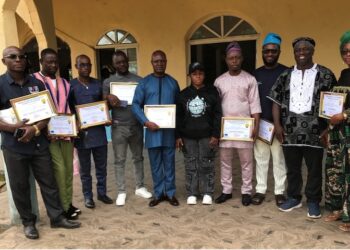 Community representatives in Cameroon hold certificates after forming Local Collaborative Management Committees to fight illegal fishing