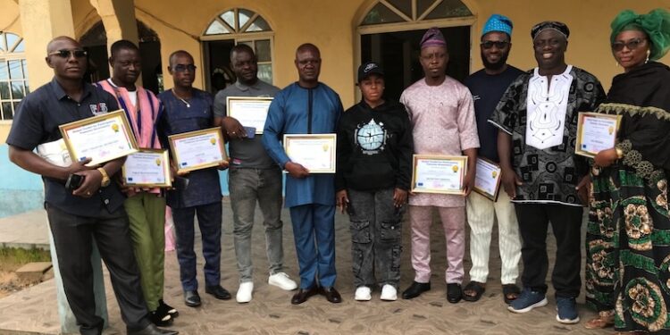 Community representatives in Cameroon hold certificates after forming Local Collaborative Management Committees to fight illegal fishing