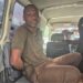 Ecobank robbery suspect Fobay Emery Johnson seated inside a police vehicle in Monrovia, accused of armed robbery and citing mental illness in court.