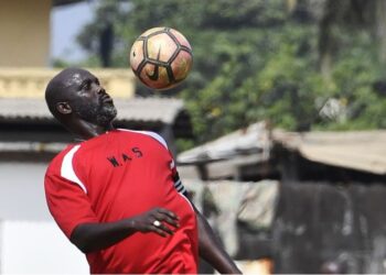 George Weah in training gear during his playing days, symbolizing his legendary football career despite his recent remarks about not being a fan
