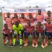 High school football team poses before kickoff at the National High School Sports Championship in Liberia.