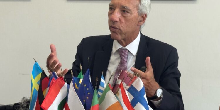 EU Sahel Envoy João Gomes Cravinho speaks in Monrovia with European and African flags on the table, warning Liberia of regional spillover risks.