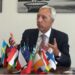 EU Sahel Envoy João Gomes Cravinho speaks in Monrovia with European and African flags on the table, warning Liberia of regional spillover risks.