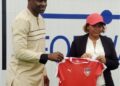 LFA President Mustapha Raji and women’s national team coach Selam Kebede hold a Liberia jersey during her unveiling as contract renewal talks begin