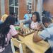 Young Liberians playing chess in Monrovia as the national federation faces leadership and funding challenges