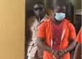 Accused Lawrence K. Williams in prison uniforms escorted by officers at the Temple of Justice
