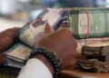 Bundles of Liberian dollar banknotes being counted, as the Central Bank assures there is no shortage in circulation.