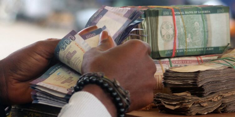 Bundles of Liberian dollar banknotes being counted, as the Central Bank assures there is no shortage in circulation.