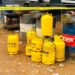 Yellow Mira Gas cylinders stacked near drums inside a restricted area in Monrovia after explosion incident.