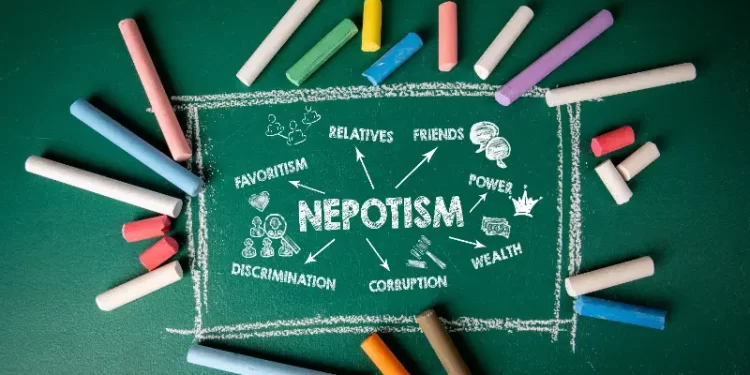green board with nepotism written on it and chalks of different colors