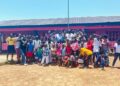 Children, parents, and community members celebrate the reopening of the renovated Comfort K. Toe Orphanage School in Christopolis, Liberia, led by Orphans Concern.