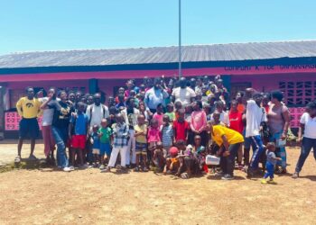 Children, parents, and community members celebrate the reopening of the renovated Comfort K. Toe Orphanage School in Christopolis, Liberia, led by Orphans Concern.