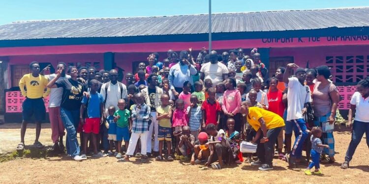 Children, parents, and community members celebrate the reopening of the renovated Comfort K. Toe Orphanage School in Christopolis, Liberia, led by Orphans Concern.