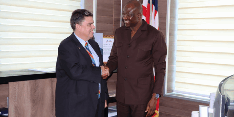 CBL Governor Henry Saamoi shakes hands with U.S. Embassy Charge d’Affaires Joseph E. Zadrozny in Monrovia during talks on gold reserves and financial cooperation