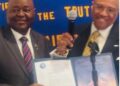 Liberian Ambassador Dr. Al-Hassan Conteh receives Honorary Membership certificate from Washington DC Rotary Club President Donnie Shaw