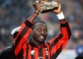 George Weah celebrates Ballon d’Or victory in AC Milan shirt.