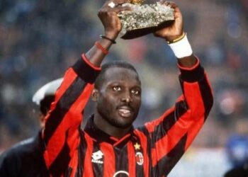 George Weah celebrates Ballon d’Or victory in AC Milan shirt.