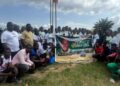 Group of Bong County students pose with a banner at the launch of William Telebo Thompson’s 5th Student Internship Program in Totota