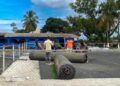 Workers install synthetic turf at Bible Way Mission School in Liberia as part of an LFA and FIFA pilot project to boost grassroots football.