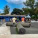 Workers install synthetic turf at Bible Way Mission School in Liberia as part of an LFA and FIFA pilot project to boost grassroots football.
