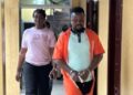 Defendant Bill Jallah being escorted from Criminal Court ‘B’ in Monrovia after being convicted of murdering his girlfriend, Princess Zuo Wesseh, in Paynesville