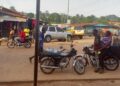 Motorcycles and riders on a busy street in Gbarnga, Bong County, where police have imposed a late-night travel ban to curb rising robberies.