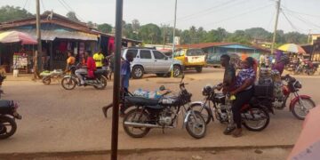 Motorcycles and riders on a busy street in Gbarnga, Bong County, where police have imposed a late-night travel ban to curb rising robberies.