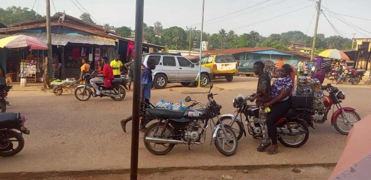 Motorcycles and riders on a busy street in Gbarnga, Bong County, where police have imposed a late-night travel ban to curb rising robberies.